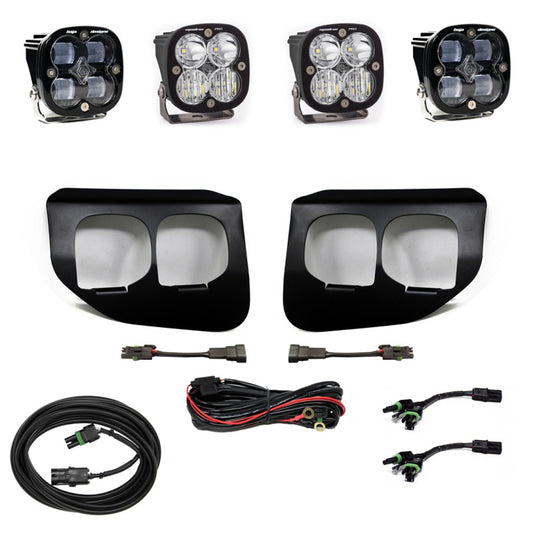 Off-road lighting kit from Baja Designs, specifically the Ford Super Duty (20-On) Fog Lights Dual FPK SAE/Pro DC model, showcasing four LED fog lights, two black mounting brackets, wiring harnesses, and connectors. Components are displayed on a white background.