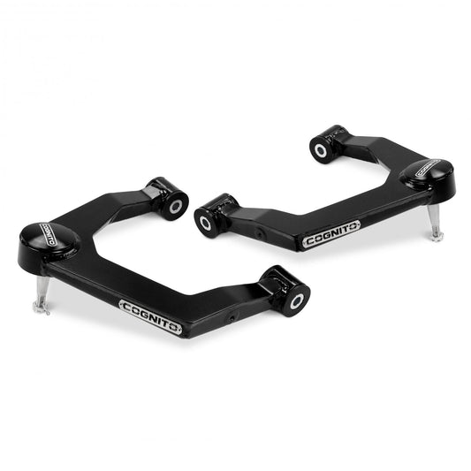 A pair of geometric-shaped black suspension control arms branded with "Cognito Motorsports," equipped with bushings at each end. This Cognito Uniball SM Series Upper Control Arm Kit is specifically designed to enhance performance in 2019-2024 Chevy Silverado and GMC Sierra 1500 models, including 2WD, 4WD, AT4, and Trail Boss variants.
