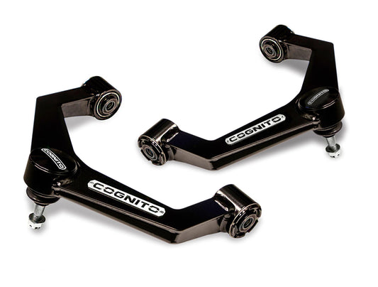 The Ball Joint SM Series Upper Control Arm Kit by Cognito Motorsports, tailored for the 2011-2019 Silverado/Sierra 2500/3500 (2WD/4WD), features black, metal upper control arms specifically designed for a vehicle's suspension system. Each arm showcases the "Cognito" branding on white labels and includes bushings and mounting hardware at each end. The angular, robust design is enhanced with Cognito ball joints to improve droop travel.