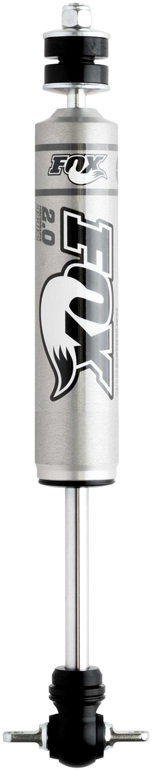 A silver and black FOX shock absorber, the Fox 99-06 Chevy 1500 2WD 2.0 Performance Series, features a corrosion-resistant design with the brand logo prominently displayed. It boasts a cylindrical body with a piston rod extending from the bottom, engineered for excellent off-road capability in vehicles or bikes with a lift of 0-1 inches.