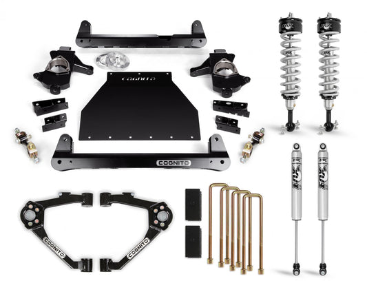 A collection of suspension components displayed on a white background. Included in the set are two Cognito Motorsports Fox PS IFP 2.0 Performance Series coilover shocks, four other shock absorbers, brackets, control arms including upper control arms to optimize ball joint angle, U-bolts, and other mounting hardware. The main components are from the Cognito 4-Inch Performance Lift Kit designed for 07-18 Silverado/Sierra 1500 2WD/4WD with OEM Cast Steel Control Arms.