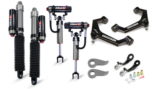 The image showcases the Cognito 3-Inch Elite Leveling Kit with Elka 2.5 Reservoir shocks for 11-19 Silverado/Sierra 2500-3500 2WD-4WD Trucks by Cognito Motorsports, featuring two Elka coilover shocks, two adjustable shocks, upper control arms, spanner wrenches, and various mounting hardware. The modern parts feature branding labels and are perfect for a Silverado leveling kit.