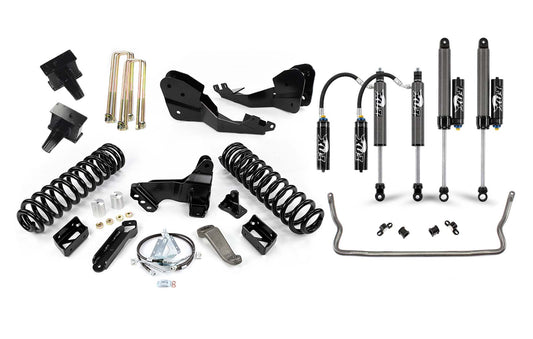A variety of vehicle suspension components laid out on a white background. Includes shock absorbers, coil springs, brackets, bolts, and other hardware, all arranged neatly. These Cognito Motorsports components appear to be part of the Cognito 4 / 5 Inch Premier Lift Kit with Fox FSRR 2.5 for a 2017-2022 Ford F-250/F-350 4WD vehicle.