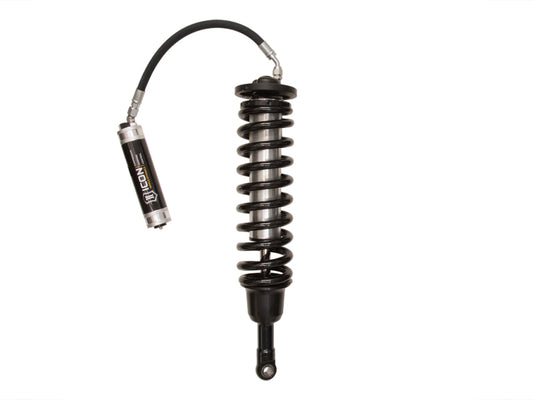 The ICON 10-14 Ford Raptor Front 3.0 Series Shocks VS RR CDCV Coilover Kit - Driver Side, designed for enhancing Ford SVT Raptor performance, showcases a black coilover suspension shock absorber with an external reservoir. Displayed against a white background, the coiled spring encircles the shock while a hose connects the reservoir to the main body for position-sensitive precision.