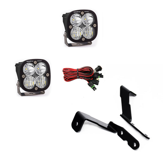 Displayed on a white background is the Baja Designs 2007-2013 GM Silverado/Sierra Squadron Sport Lights A-Pillar Kit, featuring two rectangular Squadron Sport Lights along with red and black wiring with connectors and sturdy black metal mounting brackets.