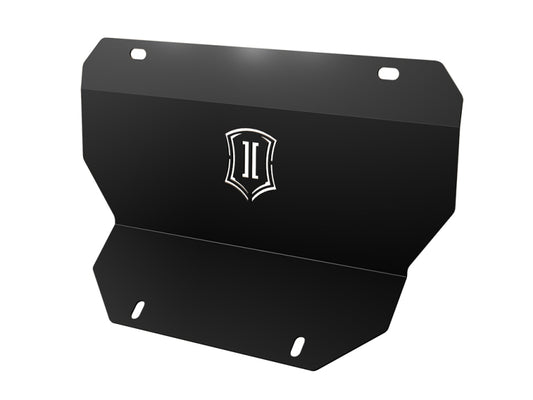 This robust plate from the ICON 2020+ GM HD Front Splash Guard Kit is crafted in black metal and highlights a logo with two vertical lines within a shield-shaped emblem. It features rounded edges and includes four mounting holes—two at the top and two at the bottom—designed to seamlessly enhance your vehicle's splash guard or suspension system.