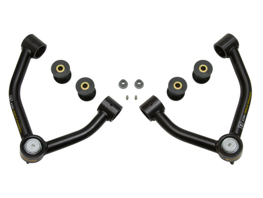 Displayed symmetrically on a white background, the ICON 2015+ Chevrolet Colorado Tubular Upper Control Arm Delta Joint Kit includes two black upper control arms with Delta Joint bushings and washers. This set, crafted by ICON, features rubber components and metal hardware designed to enhance increased wheel travel in automotive suspension systems.