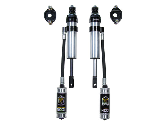 Image of a pair of ICON 11-19 GM HD 0-2in Front 2.5 Series Shocks VS RR CDCV with reservoirs, crafted by ICON for superior off-road performance. The silver and black shocks, adorned with the ICON logo, offer compression damping capabilities. Each shock comes with two additional mounting brackets above the rebuildable structure and is paired with an ICON Upper Control Arm.