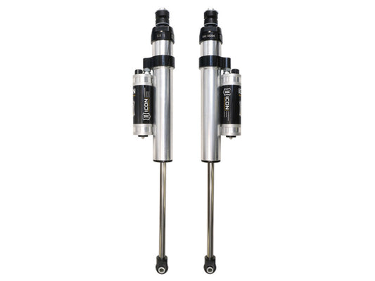 The image displays a pair of ICON 11-16 GM HD 6-8in Front 2.5 Series Shocks VS PB CDCV with attached reservoirs and black accents, neatly aligned against a white background. These shocks are engineered for superior off-road performance with enhanced compression damping force, tailored to Vehicle Specific requirements.