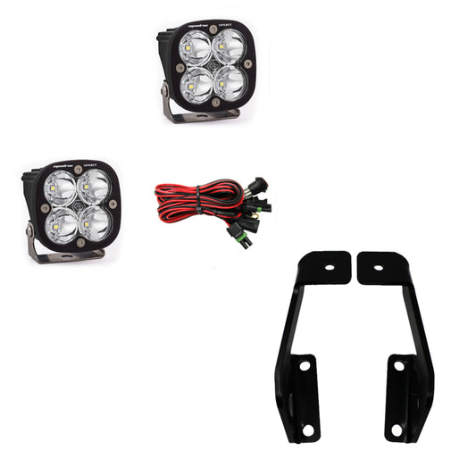 The Baja Designs Squadron Pro 2009-2014 Ford F-150 A-Pillar Kit, featuring two rectangular LED lights with four bulbs each, accompanied by a set of red and black cables with connectors and two black metal brackets, is showcased against a white background.