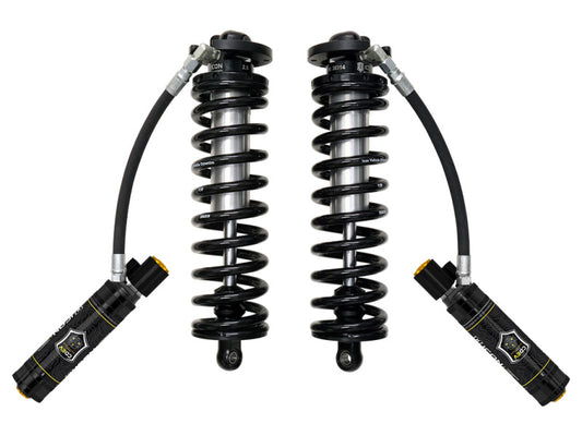 A pair of black coilover shock absorbers from the ICON 2.5 Series, featuring attached external reservoirs connected by hoses, is part of the 2017+ Ford F-250/F-350 SD 4WD 4.5-5in conversion kit. This visible branded coilover conversion kit includes adjustable components and is designed for performance-oriented applications on F-250 and F-350 trucks.