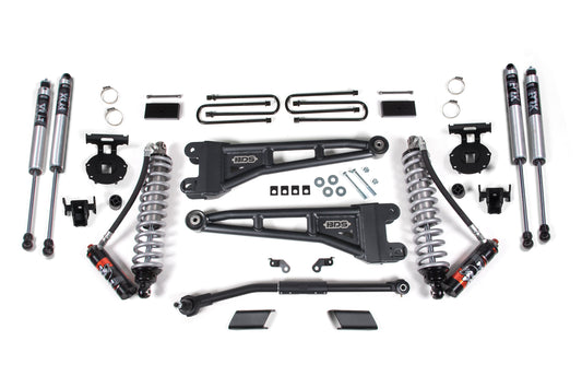 Image featuring assorted car suspension parts from the 3 Inch Lift Kit W/ Radius Arm with FOX 2.5 Coil-Over Conversion - Performance Elite, designed for the Ford F250/F350 Super Duty (2023) 4WD by BDS. The display includes FOX Performance shocks, diesel-specific Pro-Ride coil springs, control arms, brackets, clamps, and various mounting hardware. All components are neatly arranged on a white background, showcasing their organization and design.