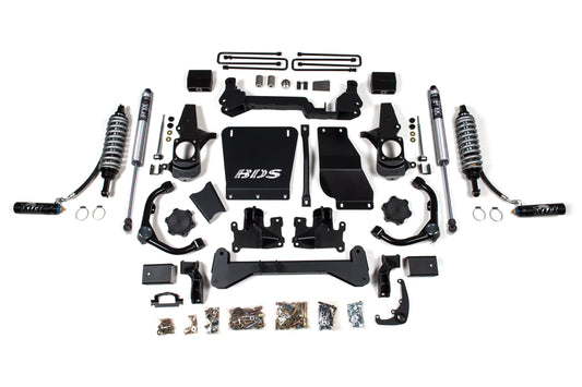 A comprehensive 6.5-inch lift kit with FOX 2.5 coil-over conversion for a Chevy Silverado or GMC Sierra 2500HD/3500HD (2001-2010) Diesel, neatly arranged on a white background. It includes shocks, brackets, bolts, and various metal parts all labeled and organized, primarily in black with hints of chrome. The brand "BDS" is visible on some parts.