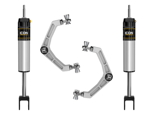 The image features four components from the ICON 20+ GM HD 0-2in IR Shock System w/Billet UCA. Symmetrically arranged on a white background are two silver shock absorbers, each labeled "ICON," alongside two upper control arms equipped with corrosion-resistant Delta Joint technology, highlighting their durability and precision engineering.