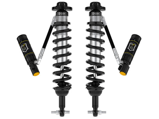 The ICON 21-UP Ford Bronco 2-3in Front 2.5 VS RR CDEV Coilover Kit is a pair of high-performance automotive shock absorbers with remote reservoirs and coil springs, designed to enhance the suspension performance of your Ford Bronco. The components boast a metallic finish with black and silver elements, featuring intricate design details and branding on the reservoirs.