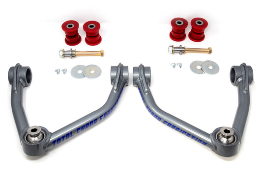 15-21 Colorado/Canyon Upper Control Arms by TOTAL CHAOS featuring two grey 4130 chromoly arms, red bushings, bolts, washers, and nuts on a white background.