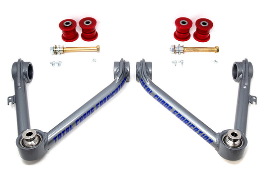 Two silver "07-18 GM 1500 Upper Control Arms" by TOTAL CHAOS are symmetrically arranged with uniballs for precision. Red bushings and metal bolts are neatly set against a white background.