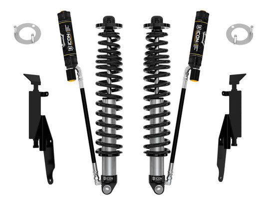 Image of the ICON 21+ Ford Bronco 2-3in Rear 2.5 VS RR CDEV Coilover Kit, featuring two black adjustable coilovers with attached reservoirs, positioned vertically. Additional mounting brackets and accessories are scattered around them on a white background, highlighting their Compression Damping Electronic Valves by ICON for enhanced performance.