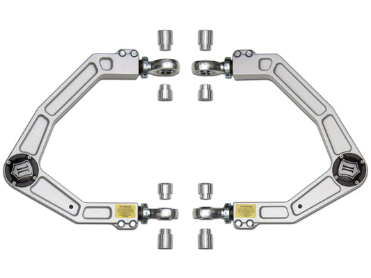 Introducing the ICON 2010+ Ford Raptor Billet Upper Control Arm Delta Joint Kit, crafted by ICON, featuring billet aluminum adjustable control arms designed specifically for the Ford Raptor. The kit includes six small cylindrical components arranged symmetrically and is equipped with labeled plates, making it ideal for performance or modified suspension systems utilizing advanced Delta Joint technology.
