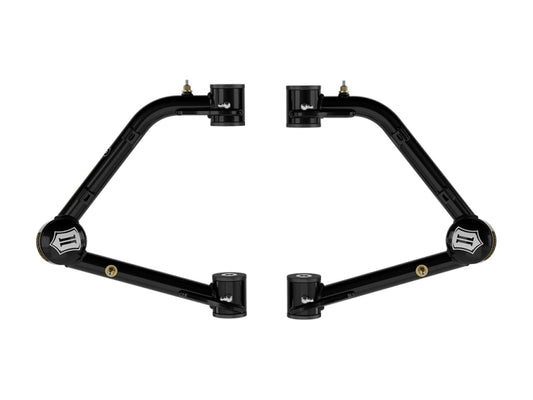 Positioned symmetrically against a white background, the ICON 2023+ GMC Canyon / 2023+ Chevrolet Colorado Tubular UCA DJ Pro Kit showcases two black metal suspension arms with cylindrical ends. Displaying logos near the mounting points, these arms are designed to enhance off-road performance with superior suspension articulation and handling.