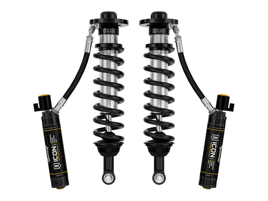 The ICON 22-23 Ford F150 Lightning Lowered Front 2.5 VS RR CDEV Coilover Kit includes a pair of black coil-over shock absorbers with attached remote reservoirs, showcasing the ICON logo and featuring an advanced CDE Valve upgrade. The design incorporates coiled springs and cylindrical reservoirs connected by hoses for a streamlined look and precise compression damping electronic valve control.